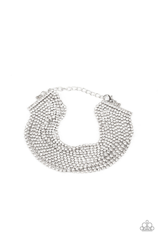 Strung between two silver fittings, sparkly strand after sparkly strand of glittery white rhinestones layer around the wrist, creating a glamorous statement piece. Features an adjustable clasp closure.