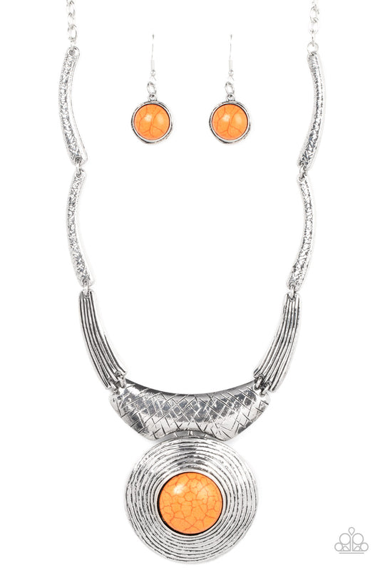 Featuring hammered, scratched, and linear patterns, an antiqued assortment of gently curving silver frames boldly links below the collar. Dotted with an oversized orange stone center, a rustic silver frame radiating with circular texture swings from the bottom for a dramatically earthy flair. Features an adjustable clasp closure.