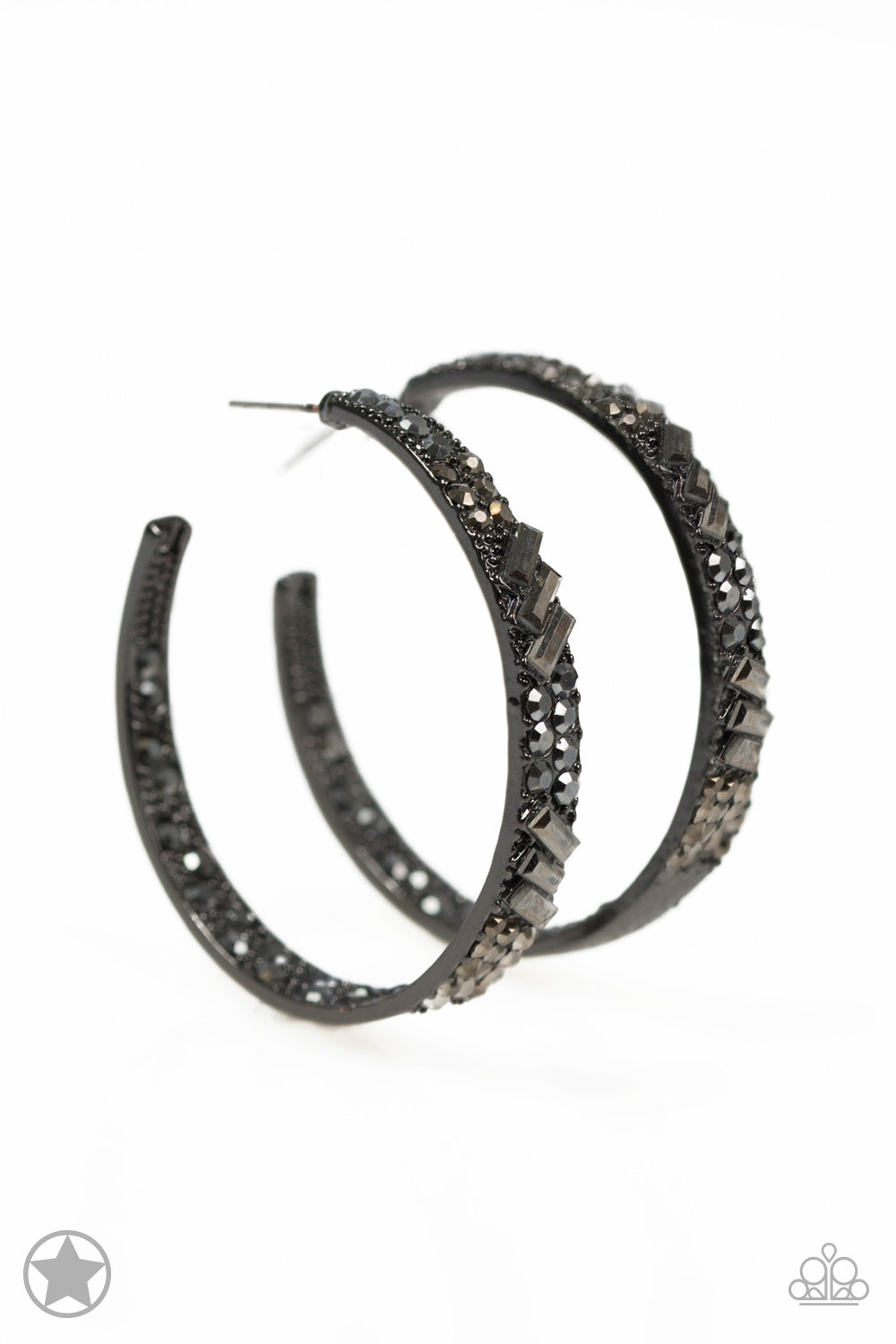 The front facing surface of a chunky gunmetal hoop is dipped in brilliantly sparkling hematite rhinestones while light-catching texture wraps around the back. The interior of the hoop features the opposite pattern, creating the illusion of a full hoop of blinding shimmer. Earring attaches to a standard post fitting. Hoop measures 1 3/4" in diameter.