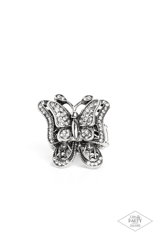 Dazzling white rhinestones are sprinkled across the wings of a silver butterfly, creating a whimsical frame atop the finger. Features a stretchy band for a flexible fit.