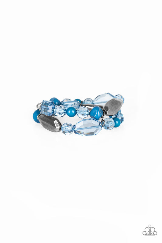 Mismatched gunmetal, polished blue, and crystal-like beads are threaded along interlocking stretchy bands for a whimsical look.