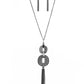 Delicately hammered in sections of shimmer, gunmetal circular frames stack into a bold pendant at the bottom of a lengthened gunmetal chain. A shimmery gunmetal tassel swings from the bottom of the stacked pendant for a casual finish. Features an adjustable clasp closure.
