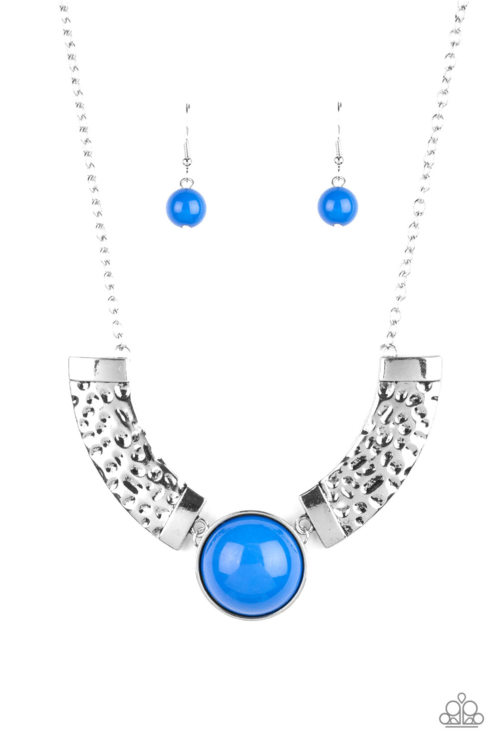 Dramatic silver plates connect with a shiny blue beaded center, creating an indigenous collar-like pendant. The shiny silver plates are delicately hammered, adding a flashy metallic texture to the tribal inspired palette. Features an adjustable clasp closure.