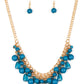 Varying in shape, glassy and polished blue beads swing from the bottom of interlocking gold chains. Crystal-like teardrops are sprinkled along the colorful beading, creating a flirtatious fringe below the collar. Features an adjustable clasp closure.
