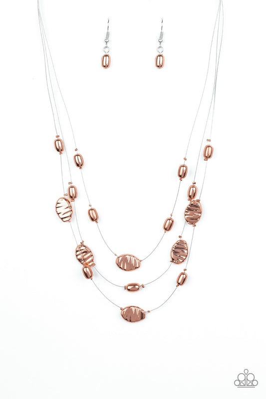 Featuring smooth and delicately hammered finishes, mismatched shiny copper beads are threaded along dainty silver wire, creating floating layers below the collar. Features an adjustable clasp closure.