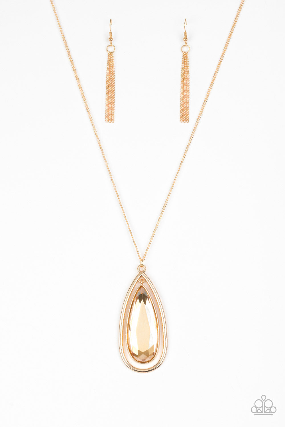An oversized golden teardrop gem swings from the top of a glistening gold teardrop frame. The dramatic pendant swings from the bottom of an elegantly elongated gold chain for a regal finish. Features an adjustable clasp closure