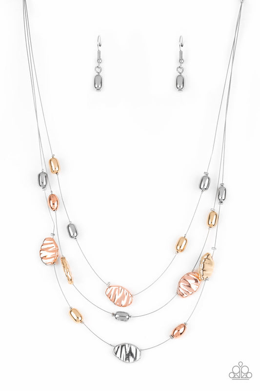 Featuring smooth and delicately hammered finishes, mismatched shiny copper, gold, and silver beads are threaded along dainty silver wire, creating floating layers below the collar. Features an adjustable clasp closure.