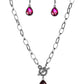 A faceted pink teardrop gem swings from the bottom of a glistening gunmetal chain, creating a classic pendant below the collar. Features a toggle closure.