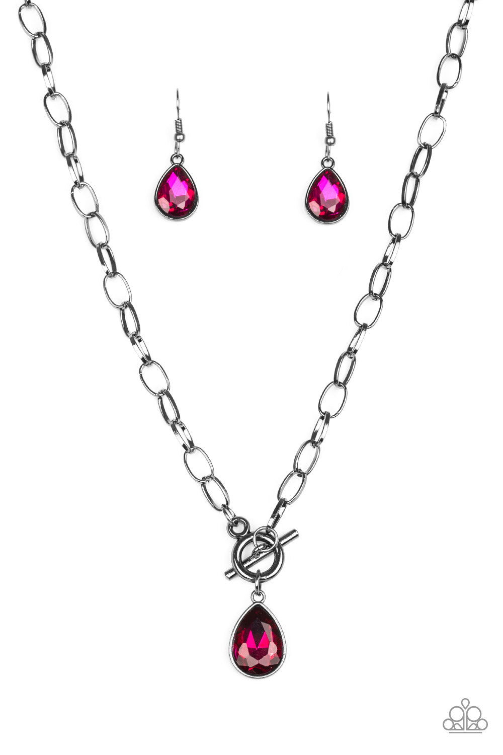 A faceted pink teardrop gem swings from the bottom of a glistening gunmetal chain, creating a classic pendant below the collar. Features a toggle closure.