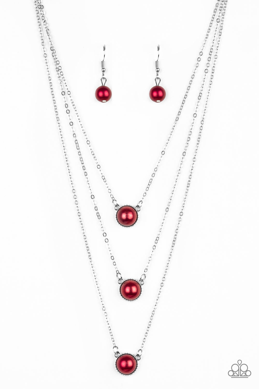Three red pearl drop pendants layer down the chest in a refined fashion. Features an adjustable clasp closure.