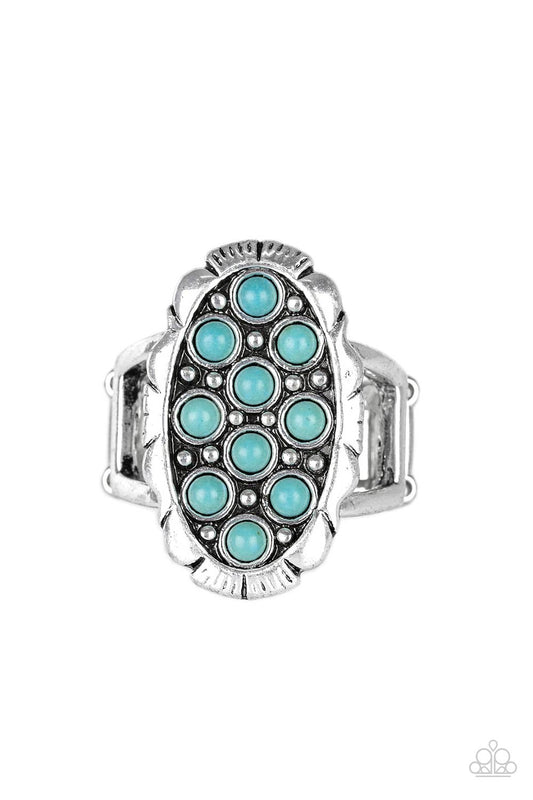 Dainty turquoise stones are sprinkled across the front of a studded silver frame, creating a refreshing centerpiece atop the finger. Features a stretchy band for a flexible fit.