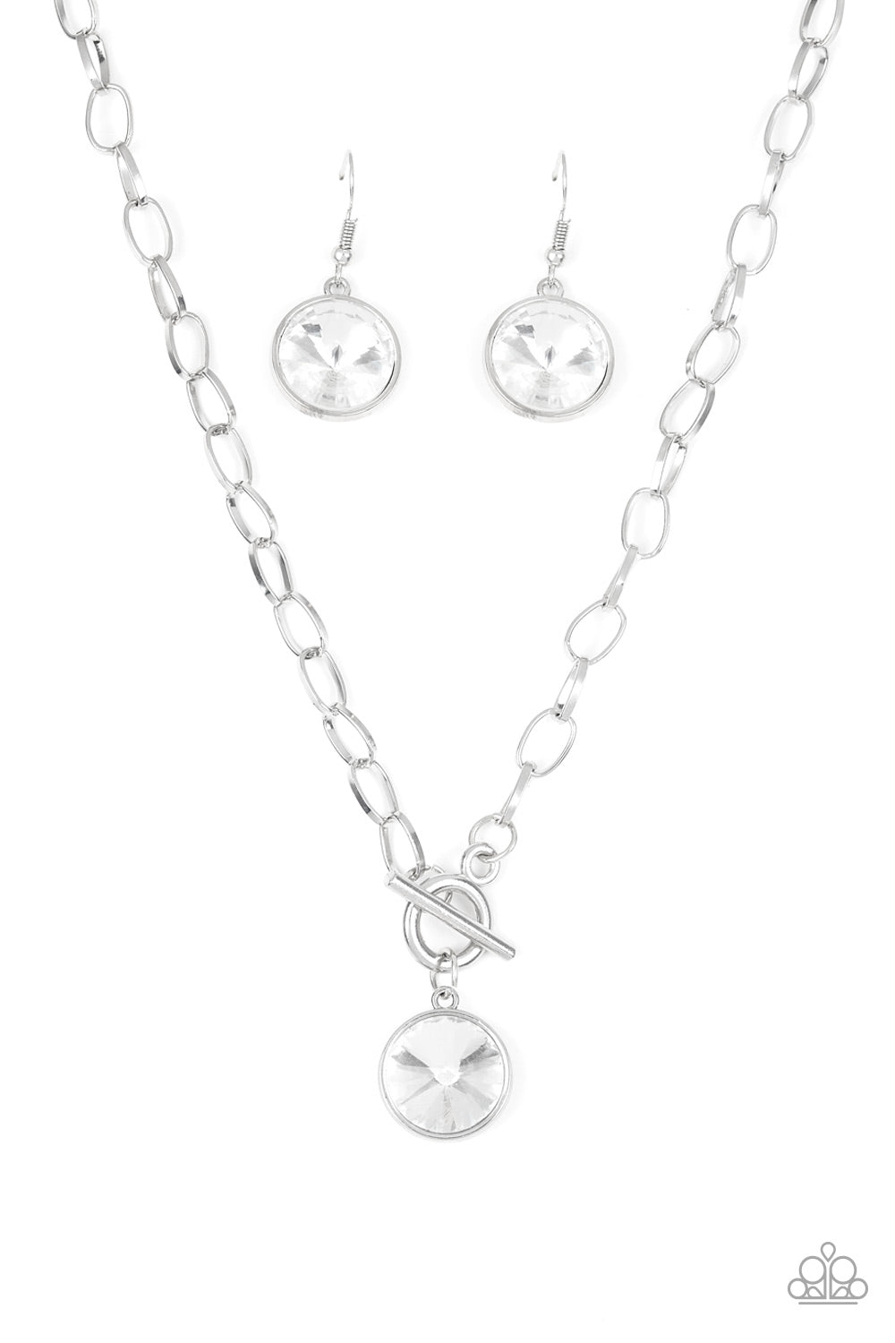 A dramatic gem white swings from the bottom of a shiny silver chain, creating a blinding pendant below the collar. Features a toggle closure.