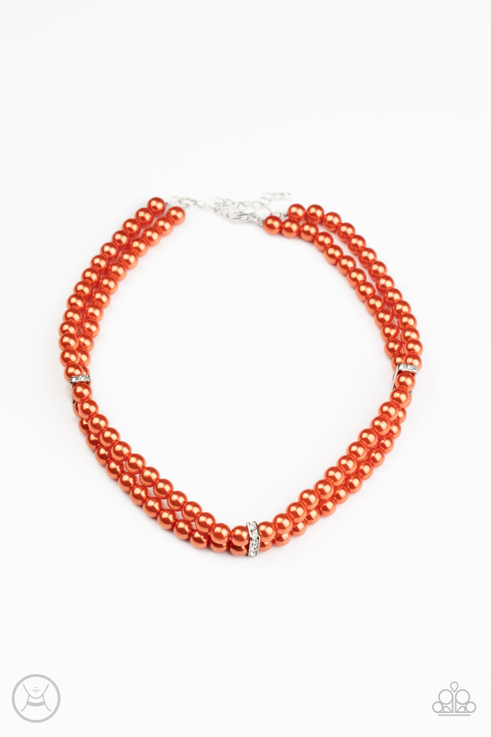 Pinched between white rhinestone encrusted frames, strands of classic orange pearls layer around the neck for a timeless look. Features an adjustable clasp closure.