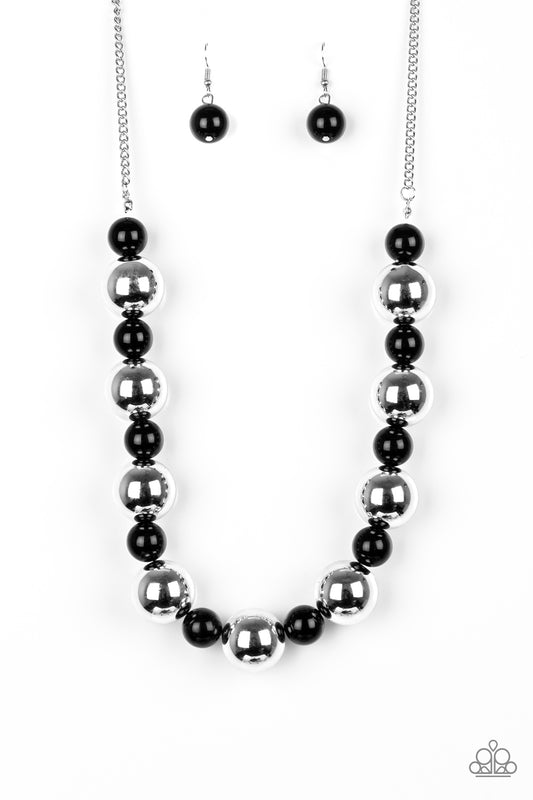 Polished black beads and dramatic silver beads drape below the collar for a perfect pop of color. Features an adjustable clasp closure.