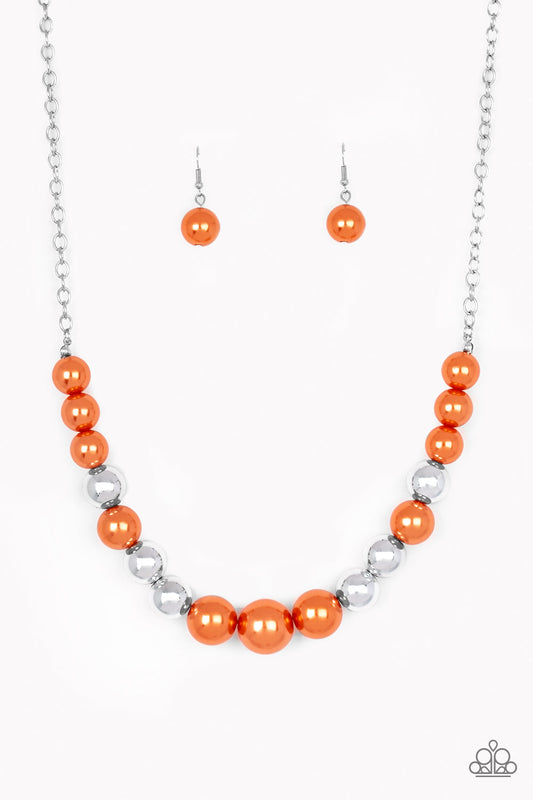 A collection of oversized silver and pearly orange beads drape across the chest for a refined look. Features an adjustable clasp closure.