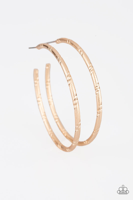 Etched in ribbons of diamond-cut shimmer, a shiny gold hoop curls around the ear for a classic look. Earring attaches to a standard post fitting. Hoop measures 2 1/4" in diameter.