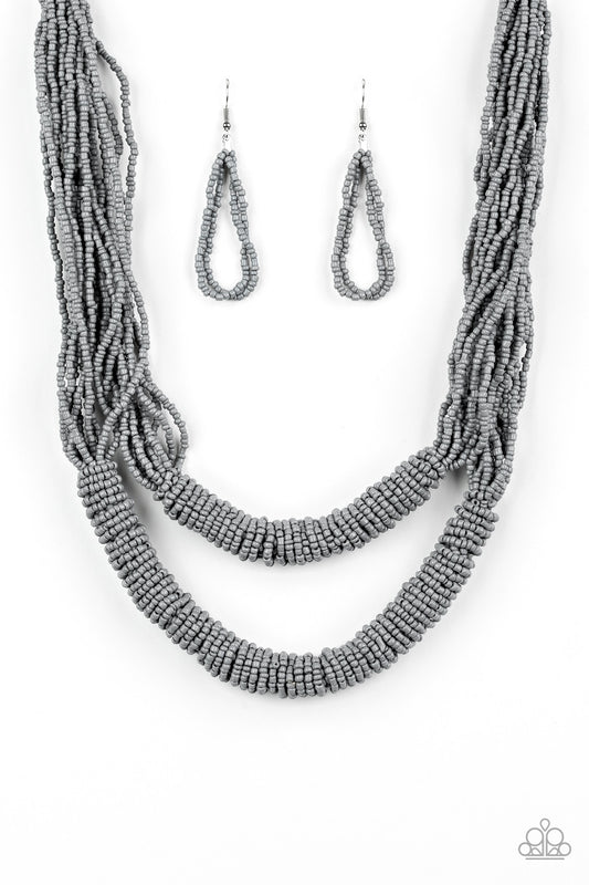 Countless layers of neutral gray seed beads drape below the collar. Additional strands of gray seed beads wrap around the center of the layers, creating two bulky rows for a seasonal flair. Features an adjustable clasp closure.