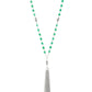 Green opaque crystal-like beads, shiny silver beads, and white rhinestone encrusted rings give way to a shimmery silver tassel for a whimsical look. Features an adjustable clasp closure.