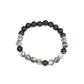 Infused with dainty silver accents, a collection of black lava rock beads and faux marble stone beads are threaded along a stretchy band around the wrist for a seasonal style.