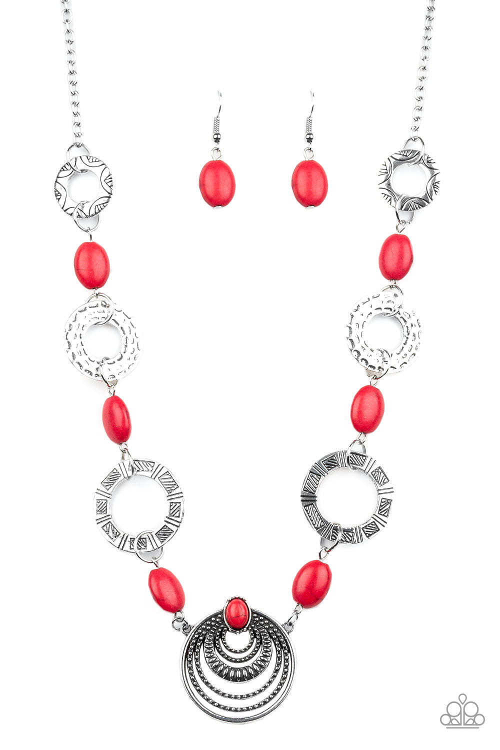 Hammered, stamped, and studded in tribal inspired patterns, a collection of ornate silver discs link with fiery red stones below the collar for a colorful flair. Features an adjustable clasp closure.  Sold as one individu