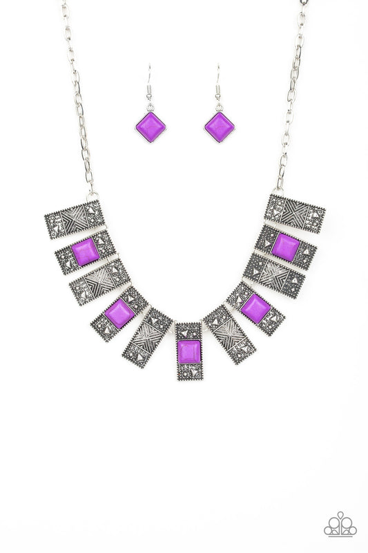 Dotted with square purple stones and pyramidal beaded centers, studded rectangular frames fan out below the collar for a trendy tribal look. Features an adjustable clasp closure.