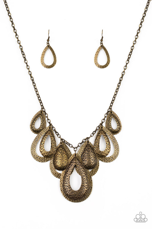 Hammered in an antiqued textured finish, pairs of mismatched brass teardrops gradually increase in size as they drip below the collar, creating a statement-making fringe. Features an adjustable clasp closure.