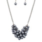 A collection of pearly gunmetal beads dangle from the bottom of a glistening gunmetal chain, creating a glamorously clustered display below the collar. Features an adjustable clasp closure.