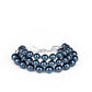 A bubbly collection of blue pearls are threaded along invisible wires, creating refined layers around the wrist. Features an adjustable clasp closure.