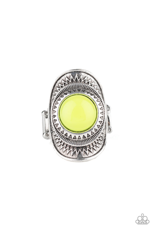 A neon yellow bead is pressed into the center of a stacked silver frame radiating with sunburst patterns, creating a flamboyant centerpiece. Features a stretchy band for a flexible fit.