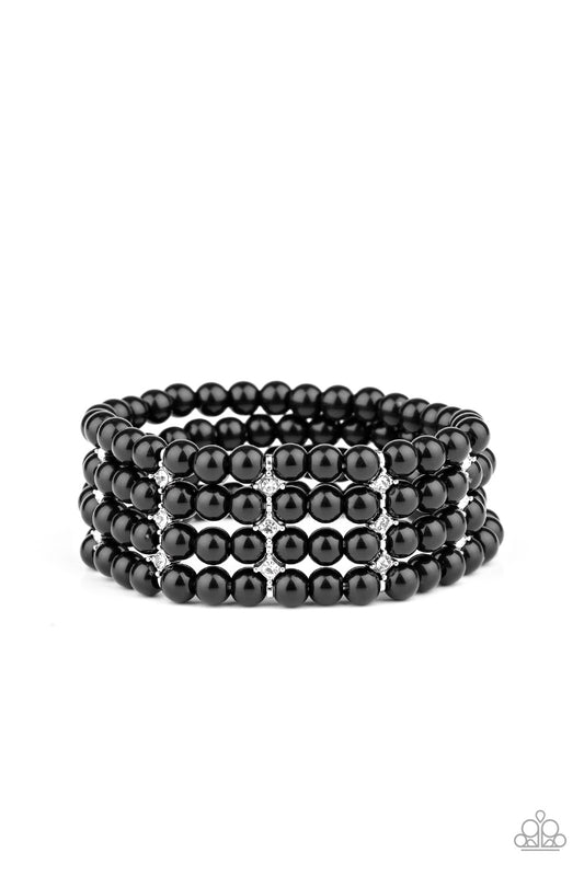 Held together by glittery white rhinestone encrusted silver fittings, row after row of shiny black beads are threaded along stretchy bands around the wrist for a timelessly stacked look.