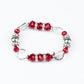 A glamorous collection of white rhinestone encrusted rings, silver beads, glassy white gems, and glittery red crystal-like beads are threaded along a stretchy band around the wrist for a refined flair.