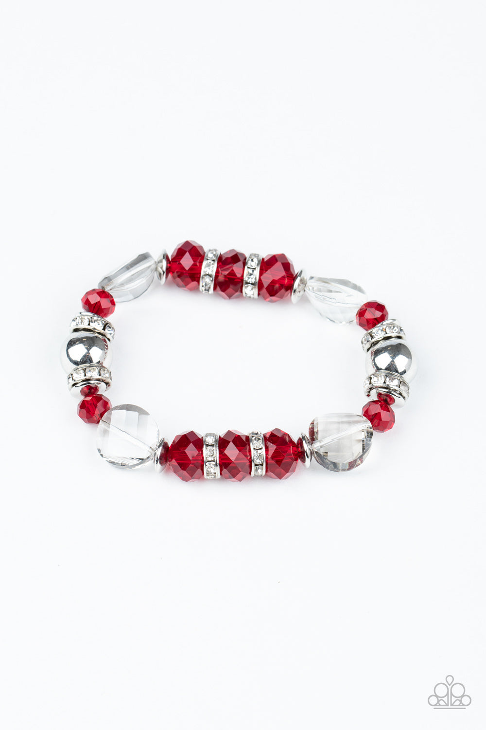 A glamorous collection of white rhinestone encrusted rings, silver beads, glassy white gems, and glittery red crystal-like beads are threaded along a stretchy band around the wrist for a refined flair.