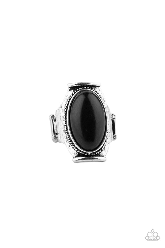 An earthy black oval stone is nestled into a hammered silver plate that folds across the finger for a seasonal flair. Features a stretchy band for a flexible fit.