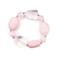 Featuring glassy, opaque, and solid finishes, an array of pink faux stone beads and dainty silver beads are threaded along a stretchy band around the wrist for a boldly colorful fashion.