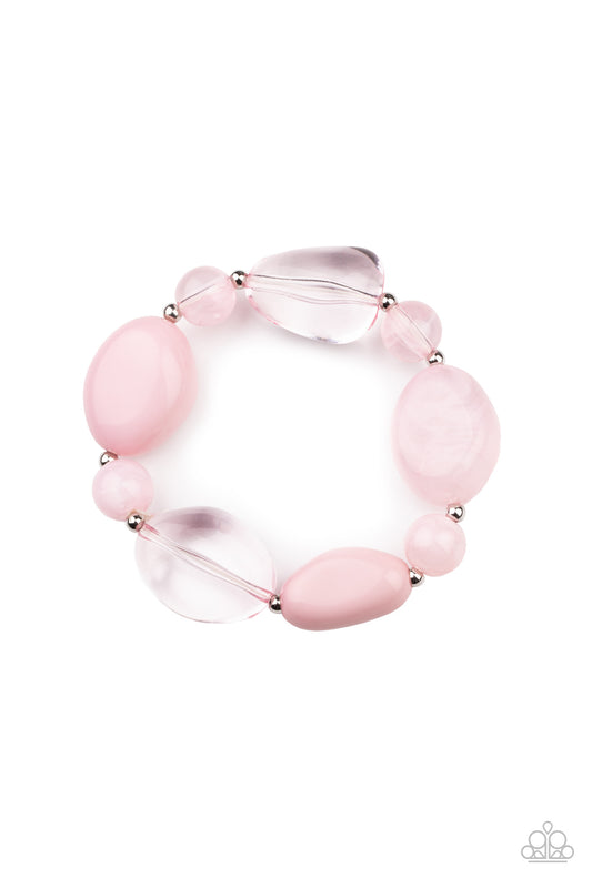 Featuring glassy, opaque, and solid finishes, an array of pink faux stone beads and dainty silver beads are threaded along a stretchy band around the wrist for a boldly colorful fashion.