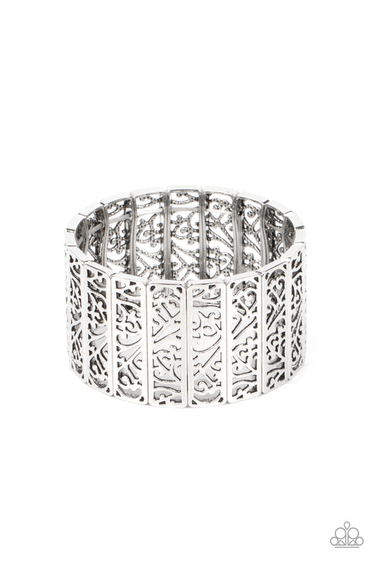 Filled with vine-like filigree centers, dainty silver rectangular frames are threaded along stretchy bands around the wrist for a seasonal inspired fashion.