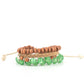 Strands of glassy green cat's eye beads stand out in an earthy collection of wooden beads and braided twine, giving a polished flair to the natural homespun look as it stacks up the wrist. Features an adjustable sliding knot closure.