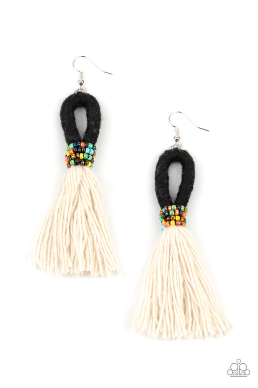 A tassel of soft white cotton fans out under rows of brightly colored seed beads. Anchored by a loop of jet black floss, the eye-catching style swings from the ear for a show-stopping statement. Earring attaches to a standard fishhook fitting.