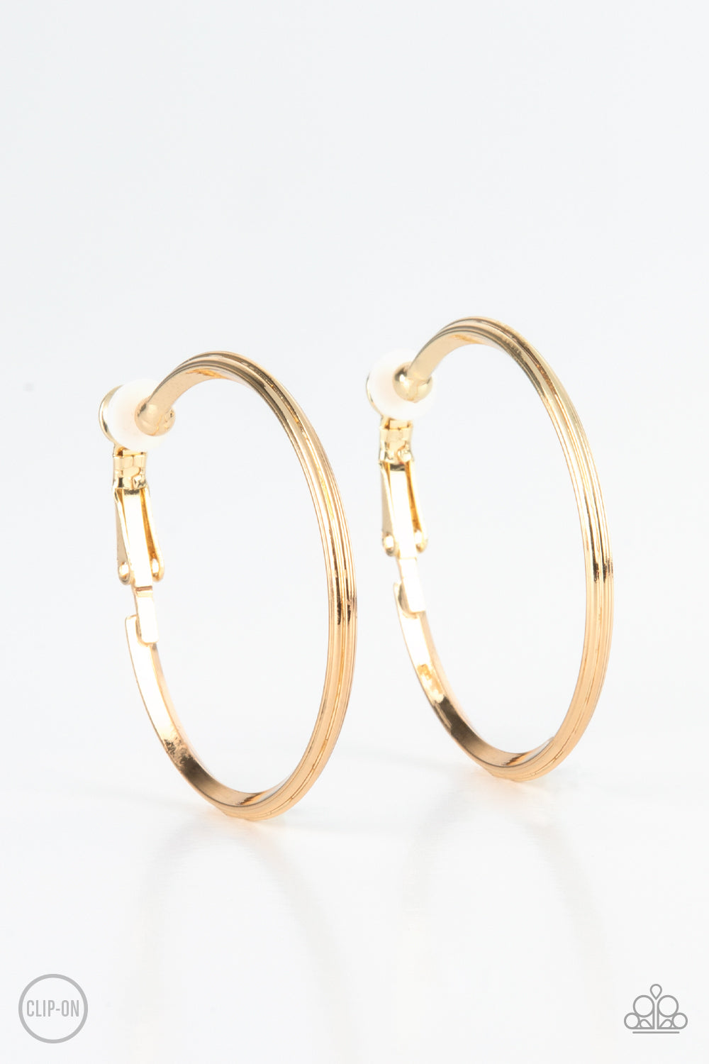 Etched in fine lines, a beveled gold hoop curls around the ear for a classic look. Hoop measures approximately 1 1/2" in diameter. Earring attaches to a standard clip-on fitting.
