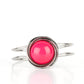 An oversized Raspberry Sorbet bead is pressed into the center of overlapping silver rings that coalesce into a dizzying centerpiece atop an airy silver bangle-like cuff, creating a bold pop of color atop the wrist. Features a hinged closure.