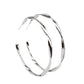 A glistening gunmetal ribbon sharply bends and twists into an oversized hoop for an intense industrial display. Earring attaches to a standard post fitting. Hoop measures approximately 2" in diameter