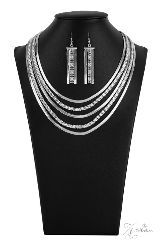 Alternating rows of flat silver snake chain and glassy strands of edgy emerald cut rhinestones sleekly layer below the collar. The deceptively simple metallic silver and white rhinestone palette is unapologetically mesmerizing, making this smooth statement piece an instant classic. Features an adjustable clasp closure.
