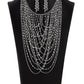 An entrancing collection of raw cut, faceted, and crystal-like silver and hematite beads delicately connect into glitzy strands that dauntlessly drape across the chest. Intermixed with plain silver chains, the swooping layers sway with every movement, creating an audaciously audible shimmer. Features an adjustable clasp closure.