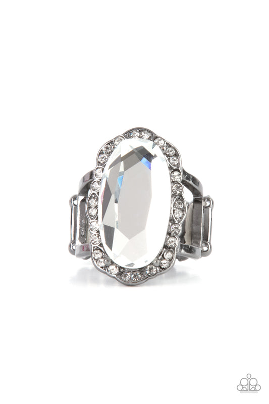 A dramatically oversized oval white gem adorns the center of a scalloped gunmetal frame dusted in dainty white rhinestones, creating a commanding centerpiece atop the finger. Features a stretchy band for a flexible fit.