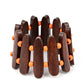 Pairs of Burnt Orange wooden beads and oblong brown wooden frames alternate along stretchy bands around the wrist for a seasonal pop of color.