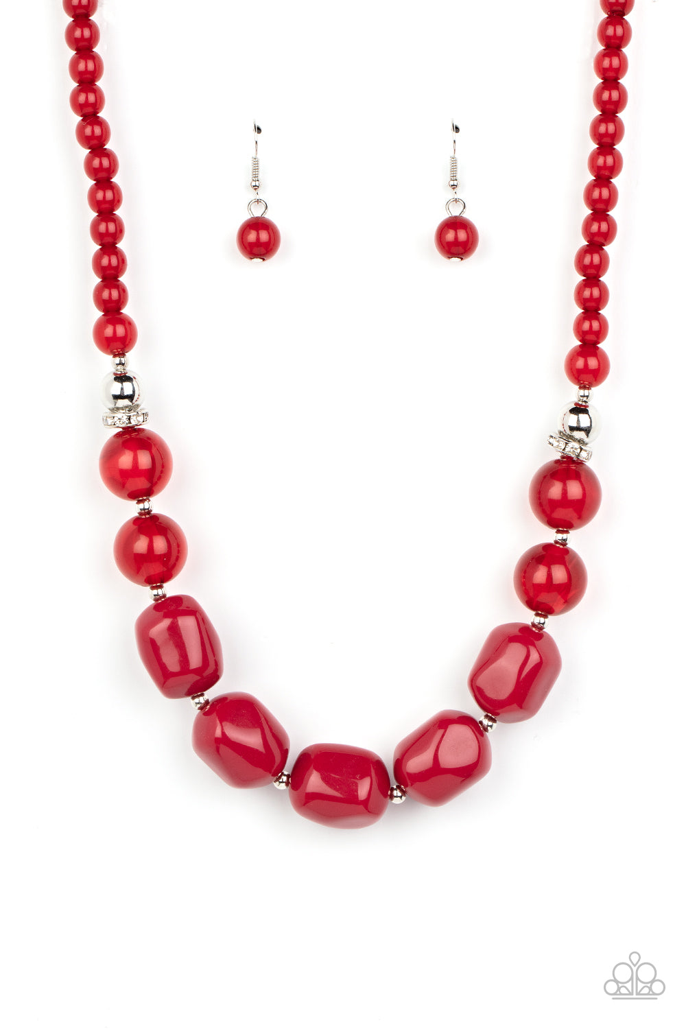 Accented with bright silver beads and glittery rhinestone accents, a row of oversized subtly faceted red beads gives way to marbled red beads that transition to smaller opaque red beads as they make their way around the collar for a modern fashion. Features an adjustable clasp closure.  Sold as one individual necklace. Includes one pair of matching earrings.