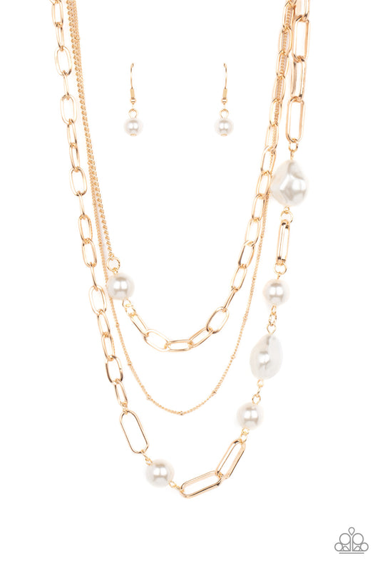 Bubbly round and imperfectly faceted white pearls haphazardly adorn an assortment of mismatched chunky and dainty gold chains, resulting in an edgy refinement below the collar. Features an adjustable clasp closure.