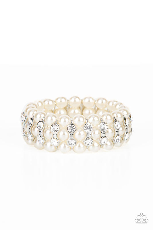 Stacked rows of bubbly white pearls alternate with white rhinestone encrusted silver frames along stretchy bands, adding a timeless twist to the traditional pearl palette.
