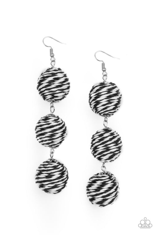 A woven collection of black and white crepe-like strings ornately wraps around three hanging beads, reminiscent of decorative party lanterns. Earring attaches to a standard fishhook fitting.