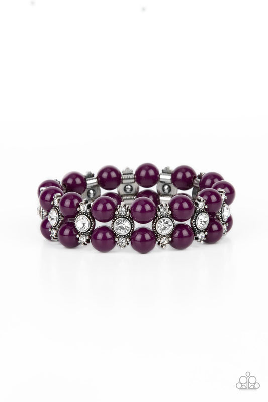 Stacked rows of bubbly plum beads alternate with white rhinestone encrusted silver frames along stretchy bands, creating a timeless pop of color around the wrist.